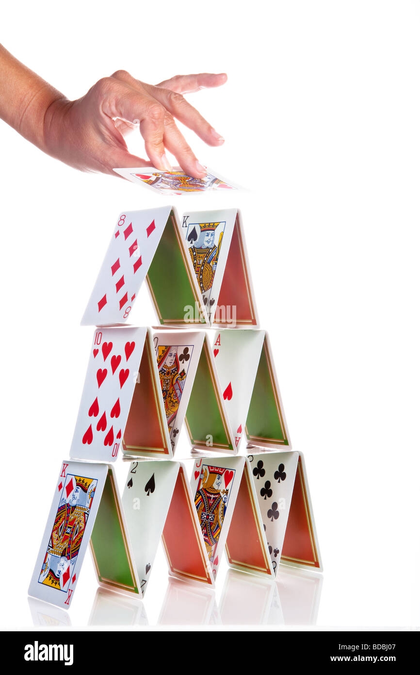 Hand Trying To Build A House Of Cards Stock Photo Alamy
